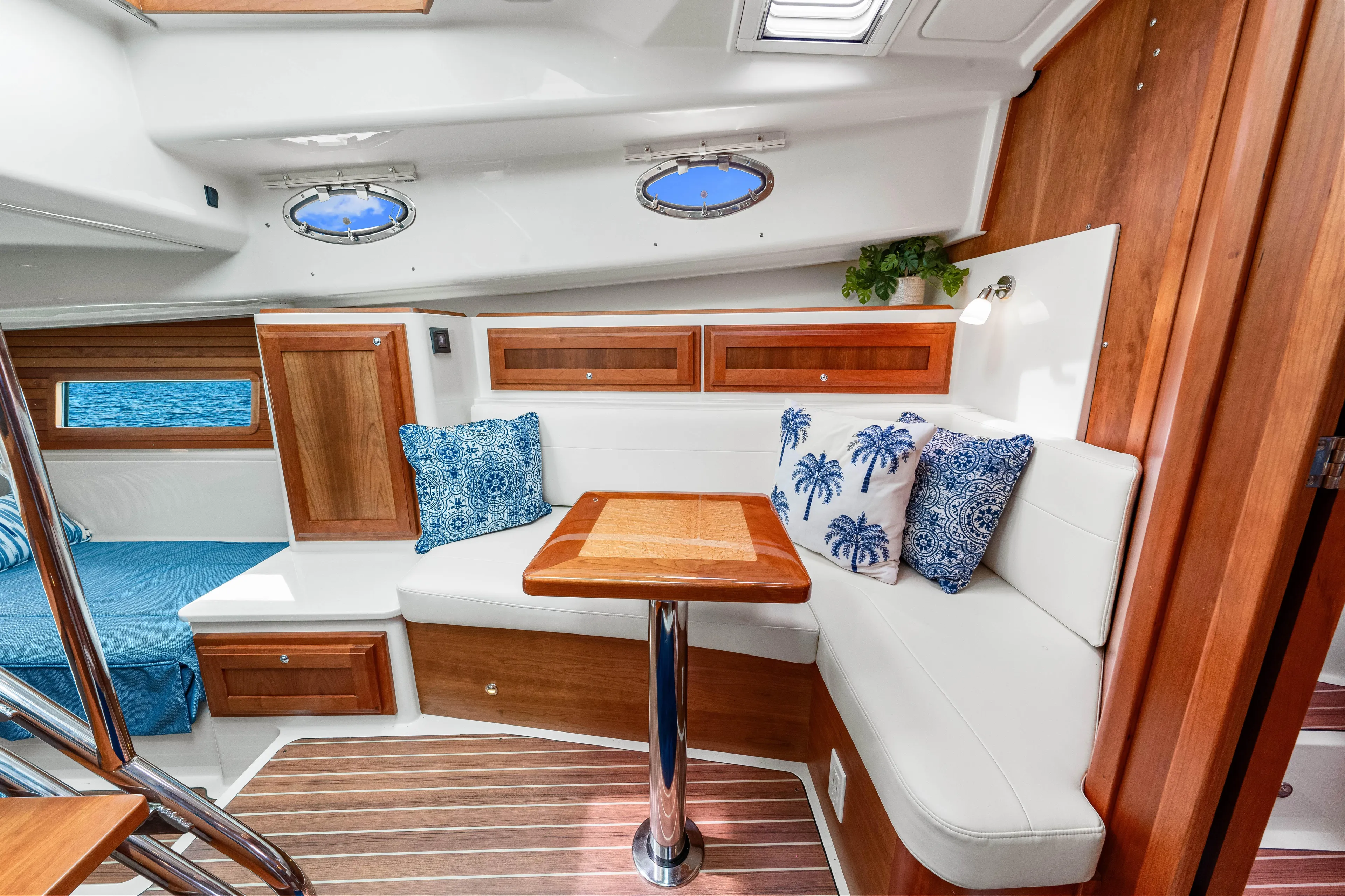  Yacht Photos Pics 2024 Back Cove 39O yacht interior with elegant seating, wooden accents, and decorative cushions.
