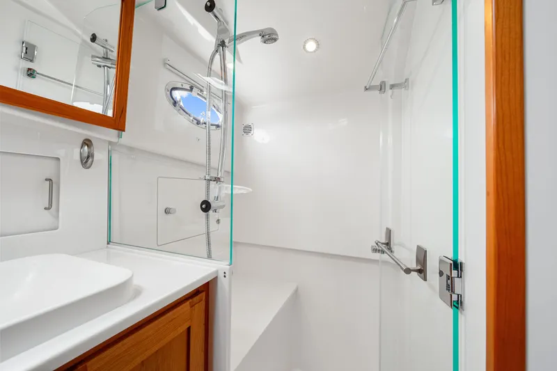  Yacht Photos Pics Luxurious bathroom in 2024 Back Cove 39O yacht with modern fixtures and wooden accents.