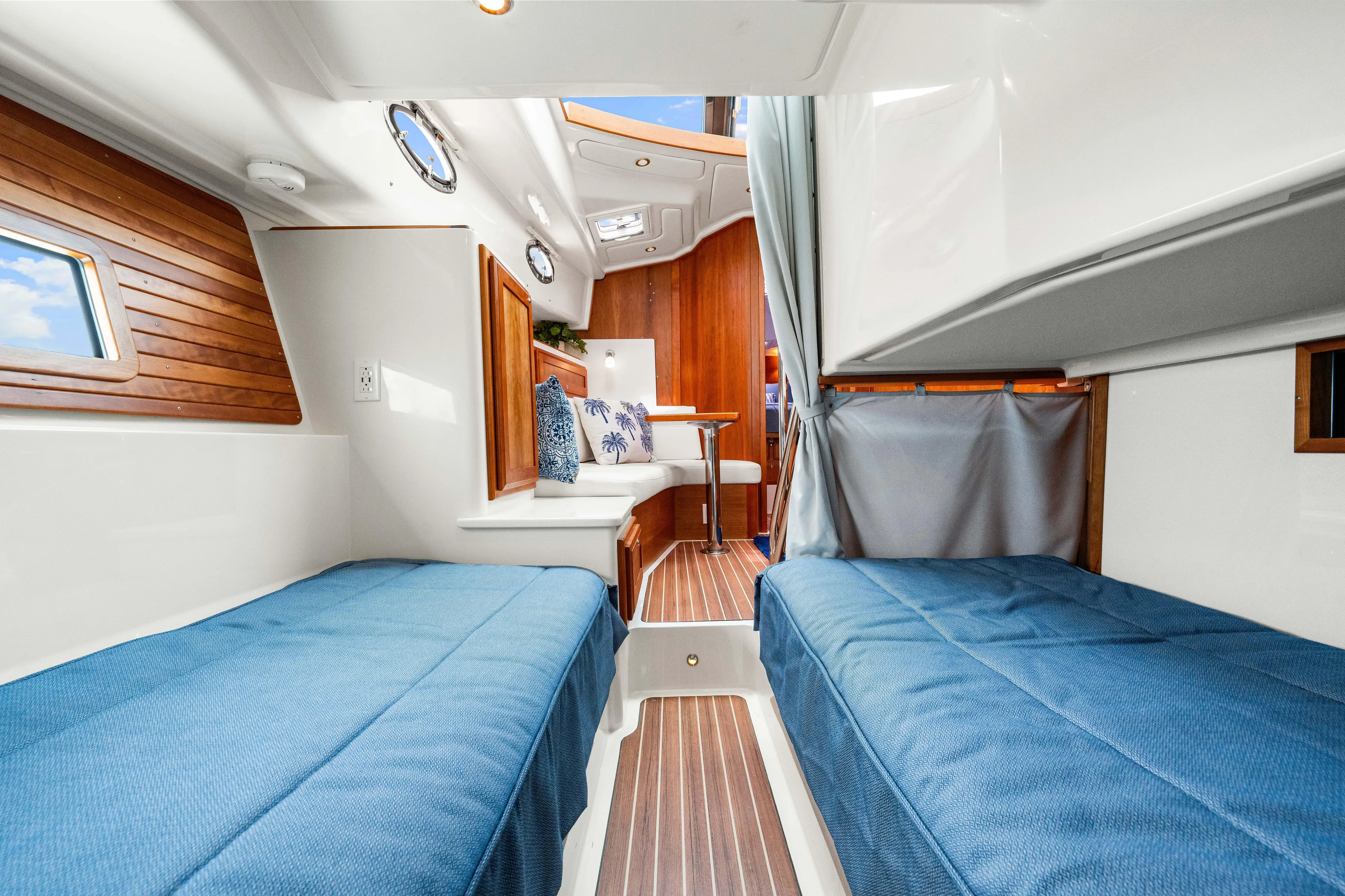  Yacht Photos Pics 2024 Back Cove 39O interior cabin with twin beds, wooden accents, and blue bedding.