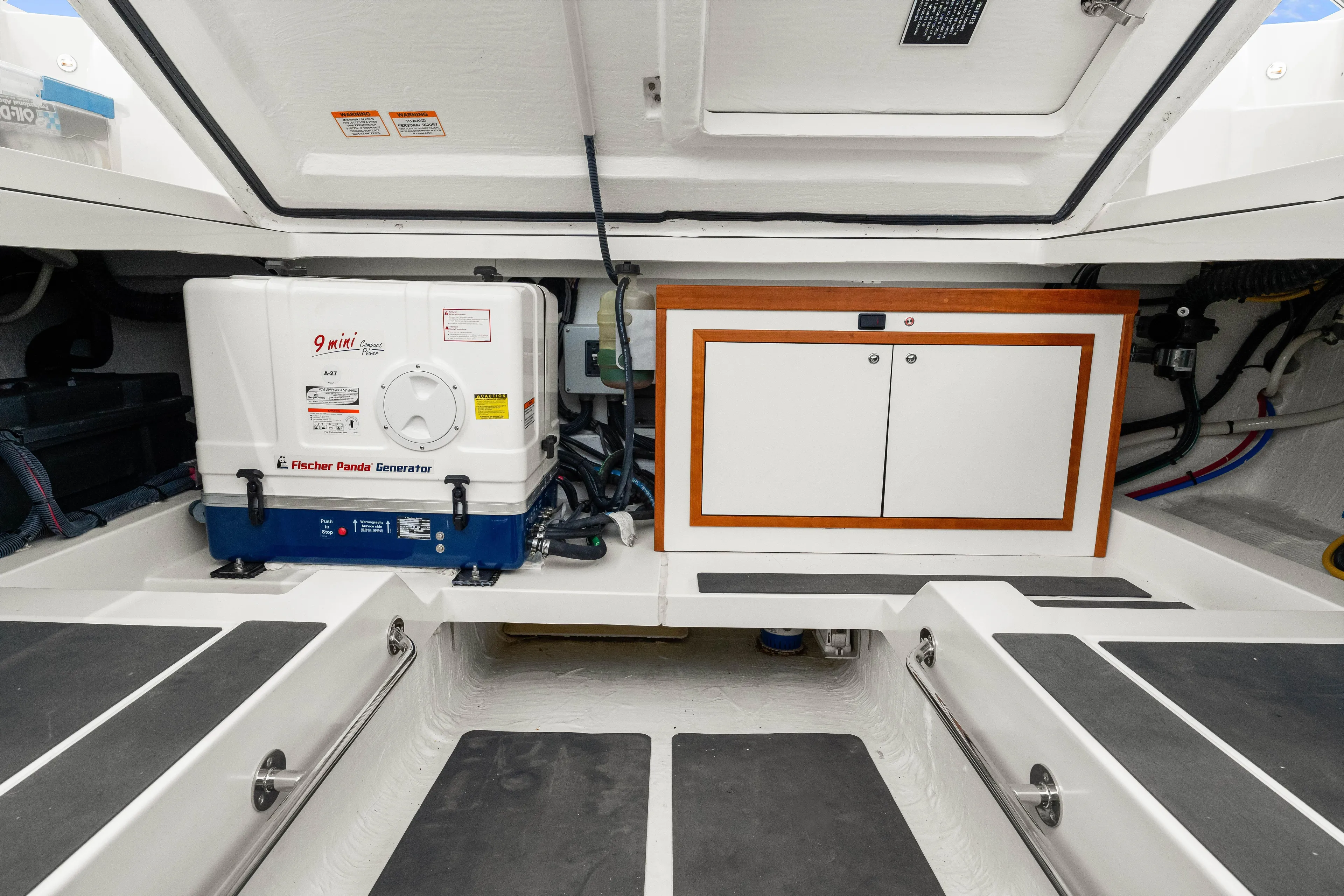  Yacht Photos Pics 2024 Back Cove 39O engine room with Fischer Panda generator and storage cabinet.