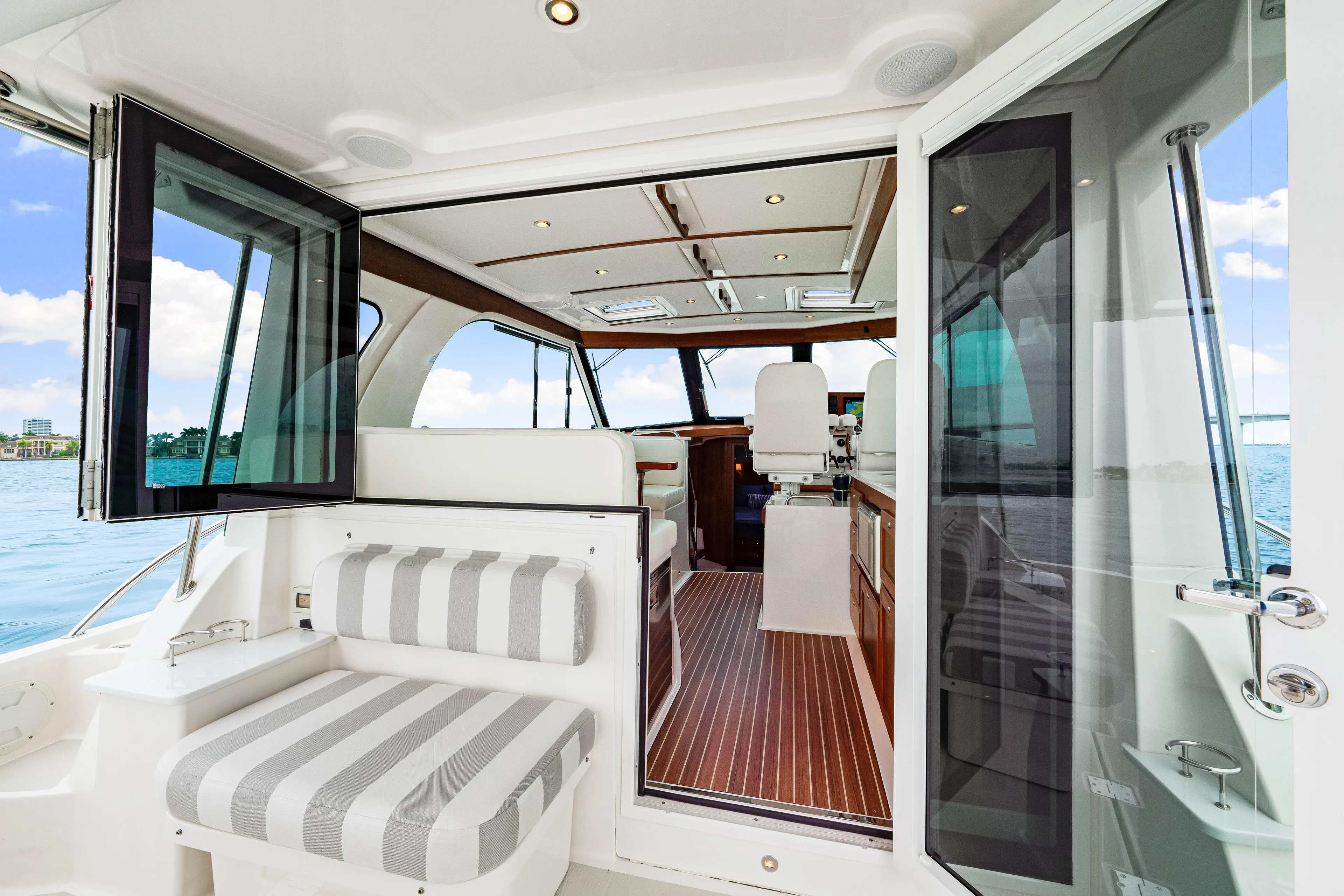  Yacht Photos Pics 2024 Back Cove 39O yacht interior with striped seating and open cabin view.