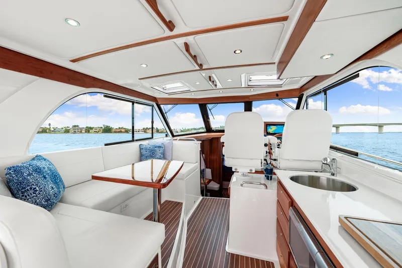  Yacht Photos Pics 2024 Back Cove 39O yacht interior with elegant seating, helm, and panoramic windows.