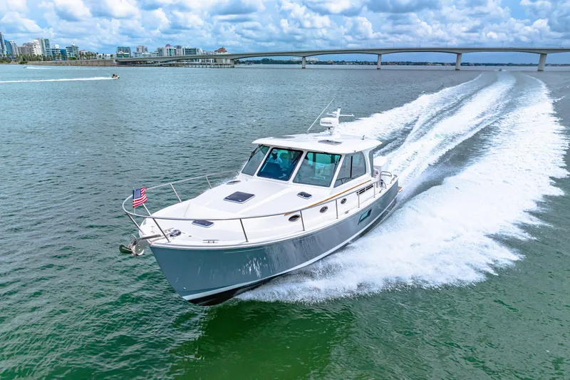  Yacht Photos Pics 2024 Back Cove 39O cruising on open water under a cloudy sky.