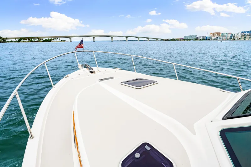  Yacht Photos Pics 2024 Back Cove 39O yacht cruising under a clear sky near a bridge.