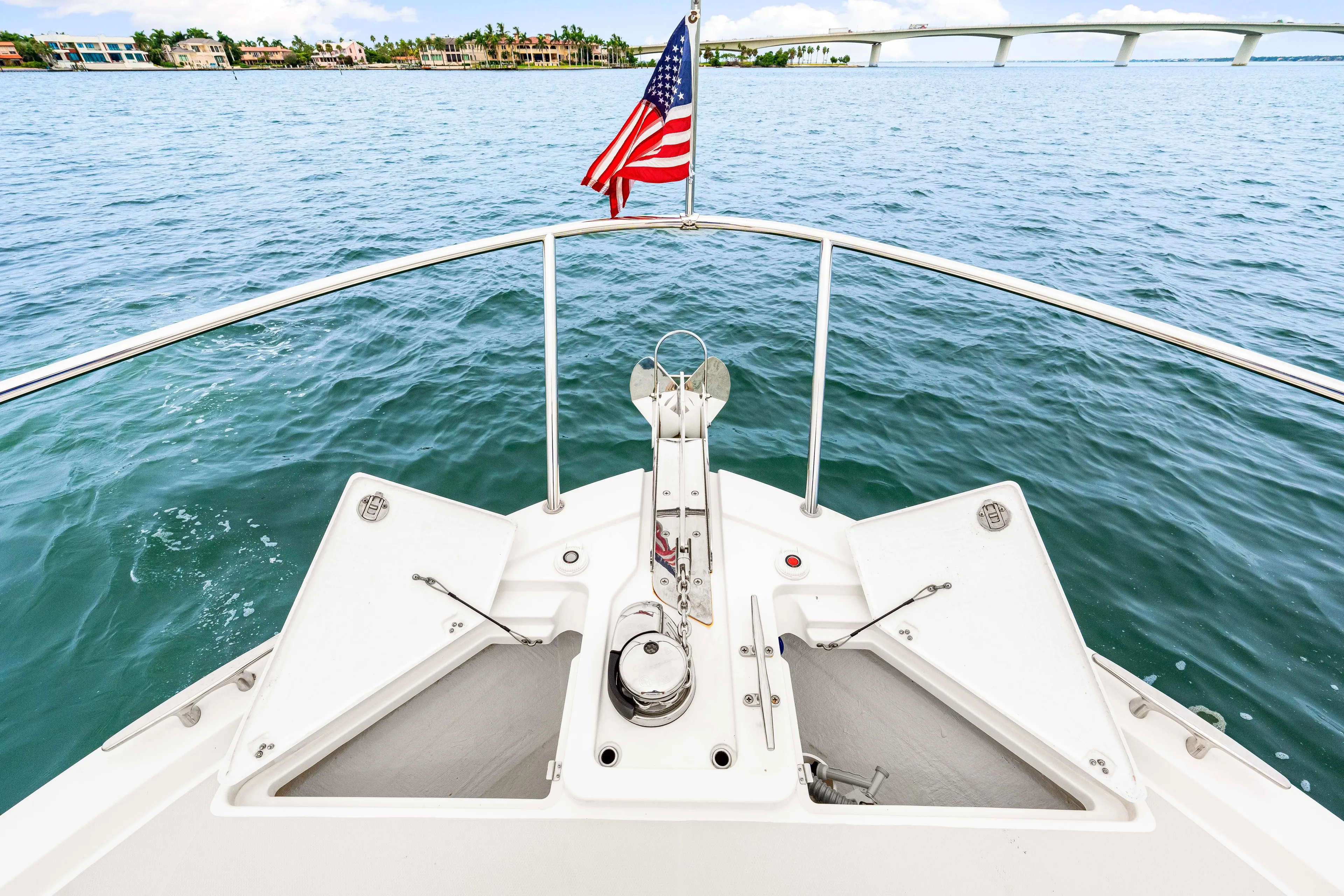  Yacht Photos Pics Bow view of 2024 Back Cove 39O yacht with American flag on open water.