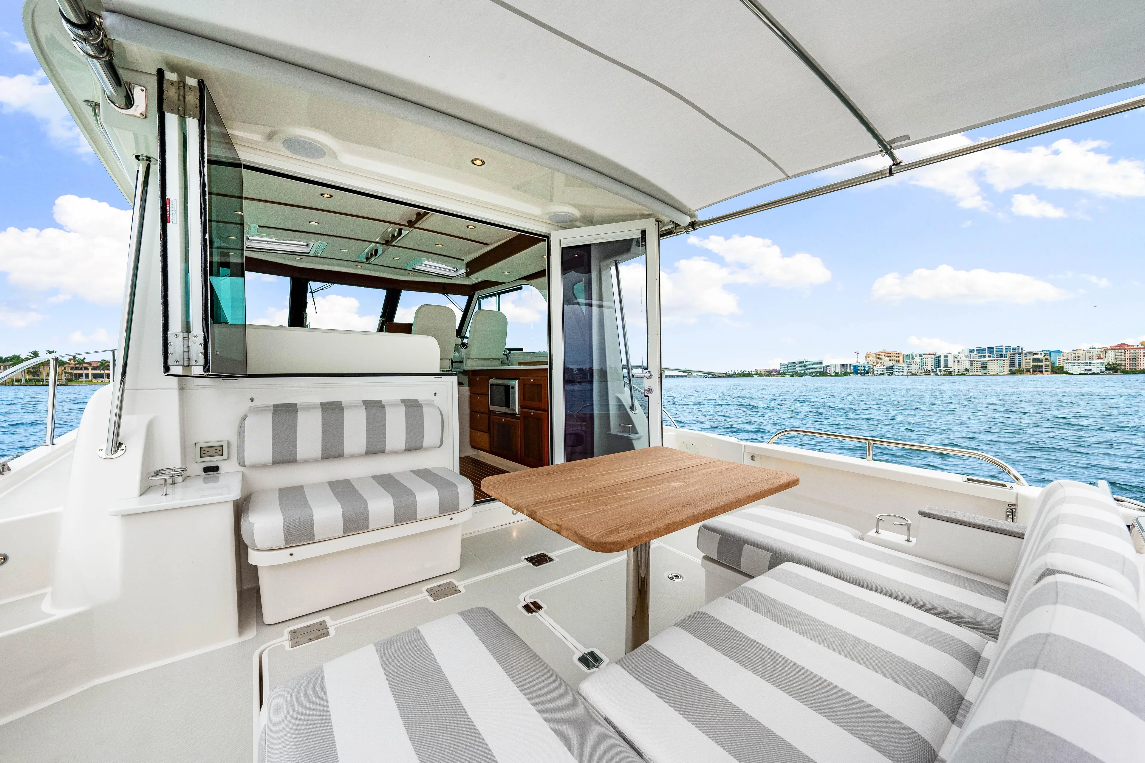  Yacht Photos Pics 2024 Back Cove 39O yacht interior with striped seating and ocean view.