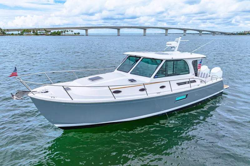  Yacht Photos Pics 2024 Back Cove 39O boat on water with bridge in background.
