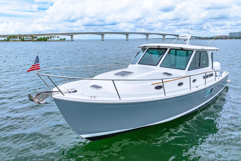 Yacht Photos Pics 2024 Back Cove 39O boat on water with bridge in background.