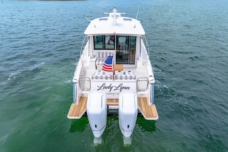  Yacht Photos Pics 2024 Back Cove 39O boat on water, rear view with American flag.
