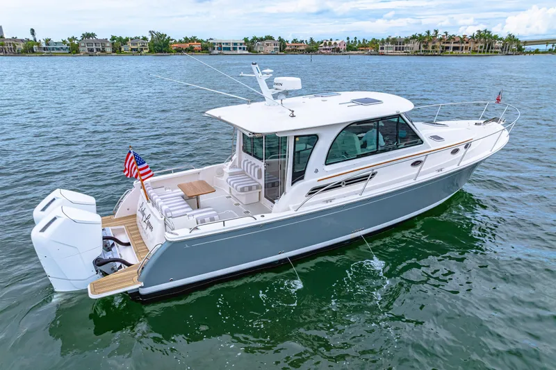  Yacht Photos Pics 2024 Back Cove 39O boat on water, featuring sleek design and spacious deck.