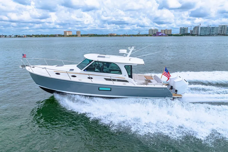  Yacht Photos Pics 2024 Back Cove 39O cruising on water, displaying sleek design and powerful engines.