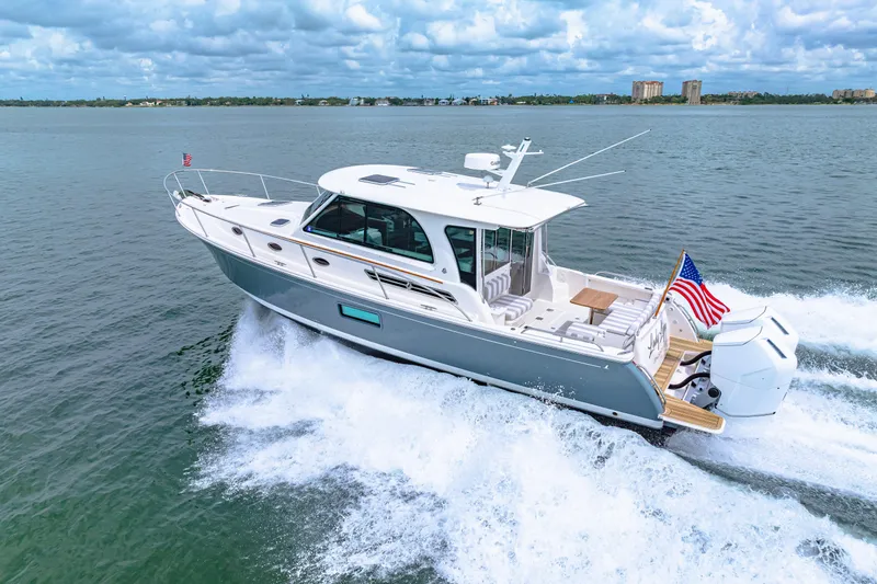  Yacht Photos Pics 2024 Back Cove 39O yacht cruising on open water, displaying sleek design and powerful engines.