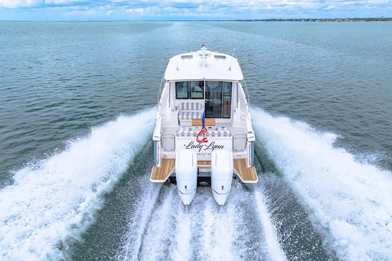  Yacht Photos Pics 2024 Back Cove 39O yacht cruising on open water, rear view.