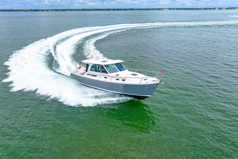  Yacht Photos Pics 2024 Back Cove 39O cruising on open water, creating a dynamic wake.