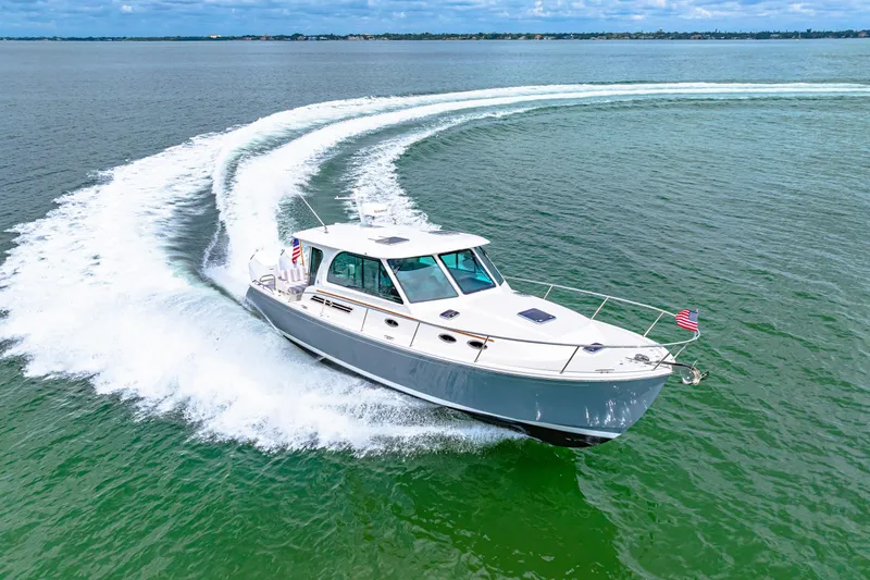  Yacht Photos Pics 2024 Back Cove 39O yacht cruising on open water, creating a dynamic wake.