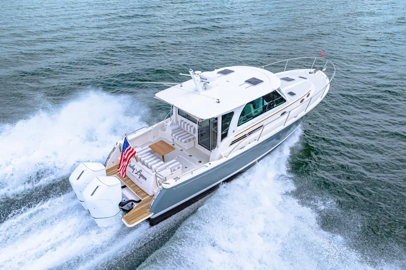  Yacht Photos Pics 2024 Back Cove 39O yacht cruising on open water, rear view.