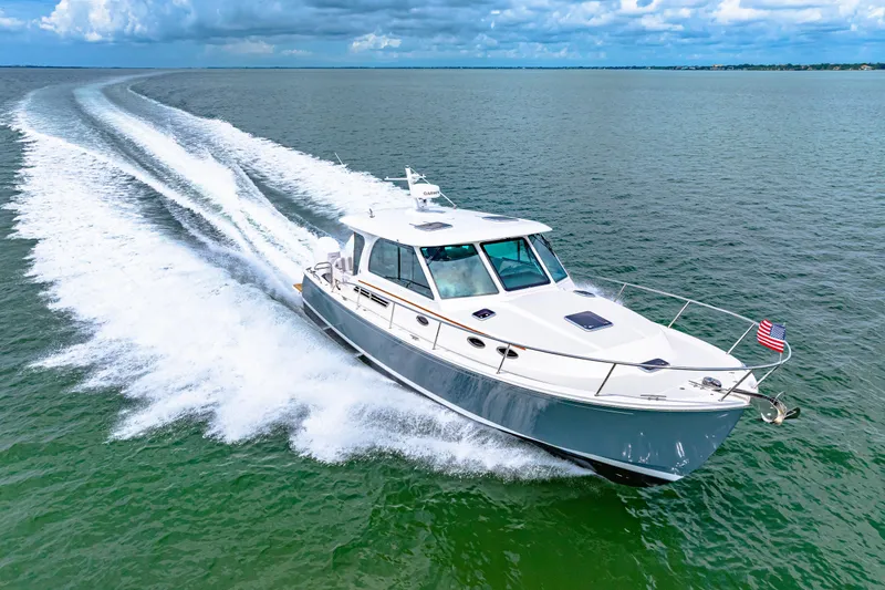  Yacht Photos Pics 2024 Back Cove 39O cruising on open water under a cloudy sky.