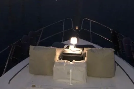 1744 Yacht Photos Pics Bow of 2003 Princess 45 Flybridge Motor Yacht with cushions and lamp at night.