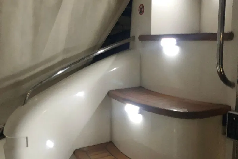 1744 Yacht Photos Pics Staircase on 2003 Princess 45 Flybridge Motor Yacht with wooden steps and metal railing.