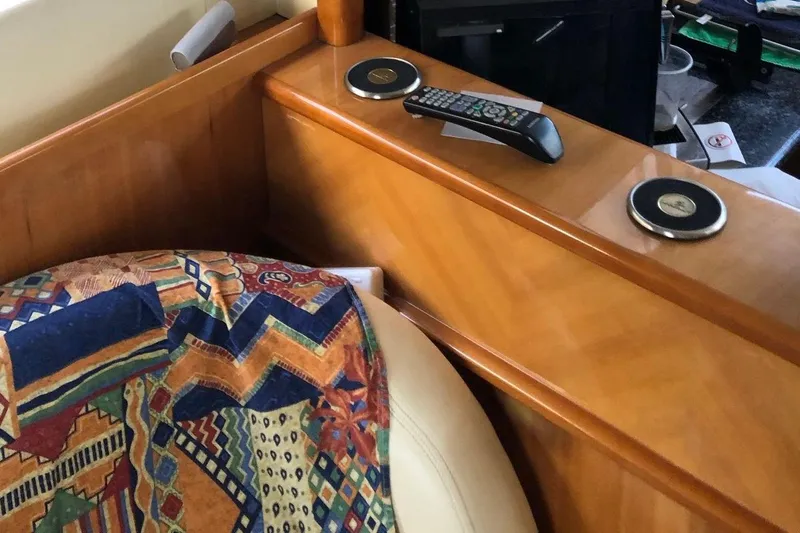 1744 Yacht Photos Pics Interior of 2003 Princess 45 Flybridge Motor Yacht with remote and colorful blanket.
