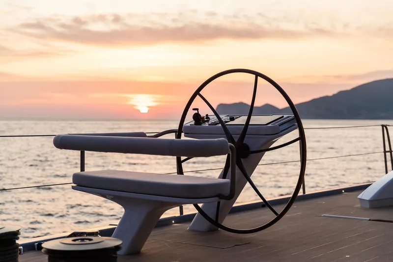 Liara Yacht Photos Pics Baltic Custom 112 yacht helm at sunset, 2019 model, serene ocean view.