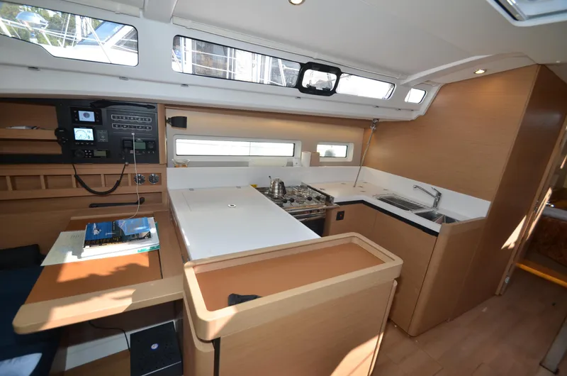 Her Intentions Yacht Photos Pics Interior of 2021 Jeanneau Sun Odyssey 440 yacht, featuring modern kitchen and navigation area.