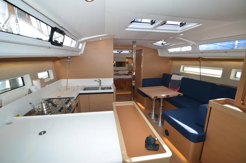 Her Intentions Yacht Photos Pics Interior of 2021 Jeanneau Sun Odyssey 440 yacht, featuring modern kitchen and seating area.