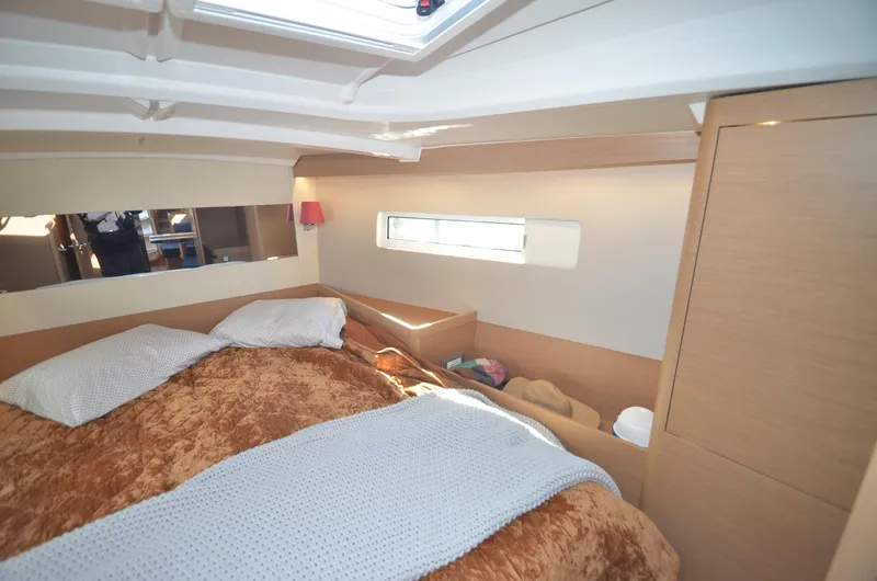 Her Intentions Yacht Photos Pics Cozy cabin interior of 2021 Jeanneau Sun Odyssey 440 yacht with plush bedding.
