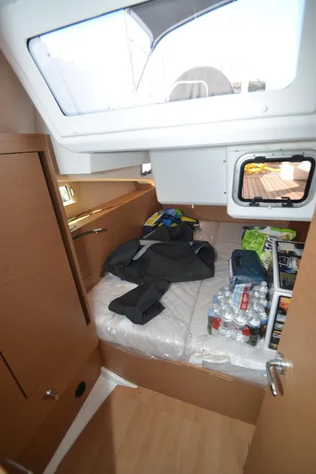 Her Intentions Yacht Photos Pics Interior cabin of 2021 Jeanneau Sun Odyssey 440 yacht with storage and supplies.