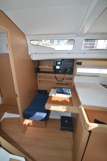 Her Intentions Yacht Photos Pics 2021 Jeanneau Sun Odyssey 440 interior with navigation station and seating area.