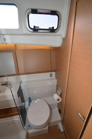 Her Intentions Yacht Photos Pics 2021 Jeanneau Sun Odyssey 440 bathroom with modern fixtures and wooden cabinetry.
