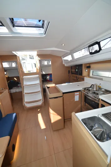 Her Intentions Yacht Photos Pics Interior of 2021 Jeanneau Sun Odyssey 440 sailboat, featuring modern kitchen and seating area.