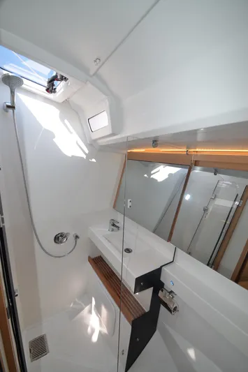 Her Intentions Yacht Photos Pics Modern bathroom in 2021 Jeanneau Sun Odyssey 440 yacht with sleek fixtures and natural light.