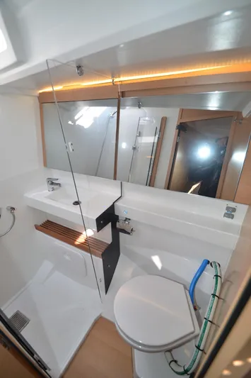 Her Intentions Yacht Photos Pics Modern bathroom in 2021 Jeanneau Sun Odyssey 440 yacht with sleek fixtures and glass shower.