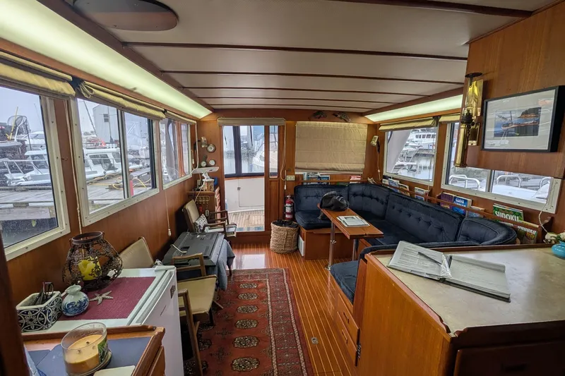 Moments Notice Yacht Photos Pics Interior of a 1981 Sea Ranger 47 yacht with cozy seating and nautical decor.