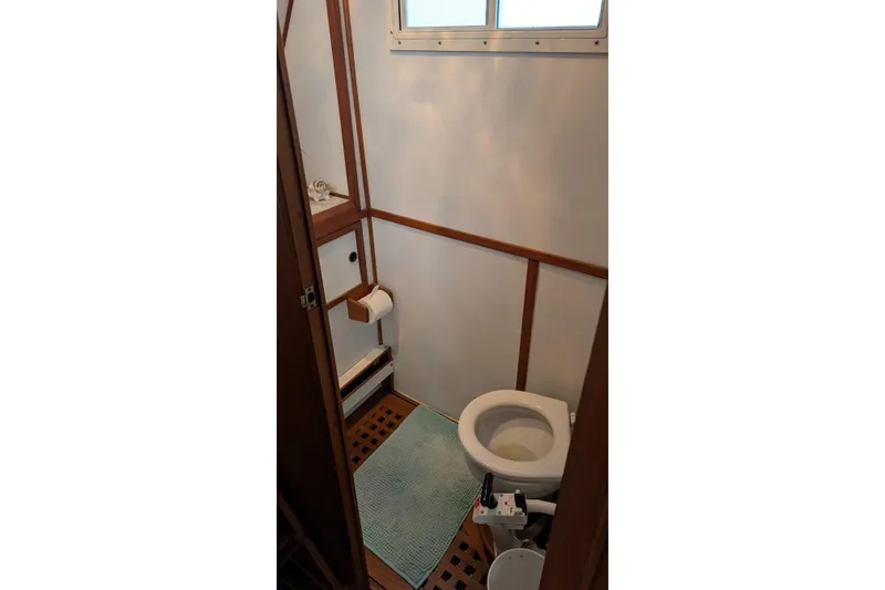Moments Notice Yacht Photos Pics 1981 Sea Ranger 47 yacht bathroom with wooden accents and marine toilet.