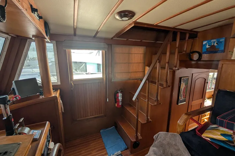 Moments Notice Yacht Photos Pics Interior of 1981 Sea Ranger 47 yacht with wooden stairs and nautical decor.