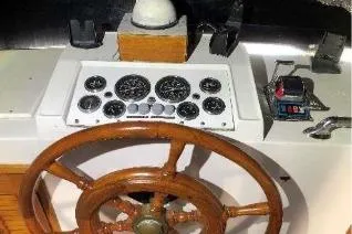 Moments Notice Yacht Photos Pics Wooden steering wheel and control panel of 1981 Sea Ranger 47 yacht.