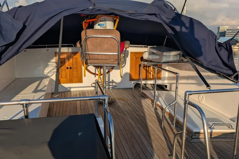 Moments Notice Yacht Photos Pics 1981 Sea Ranger 47 yacht deck with seating, wooden flooring, and protective canopy.