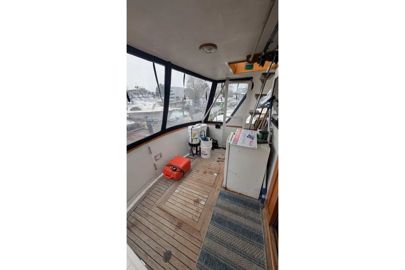 Moments Notice Yacht Photos Pics 1981 Sea Ranger 47 boat interior with wooden flooring and nautical equipment.
