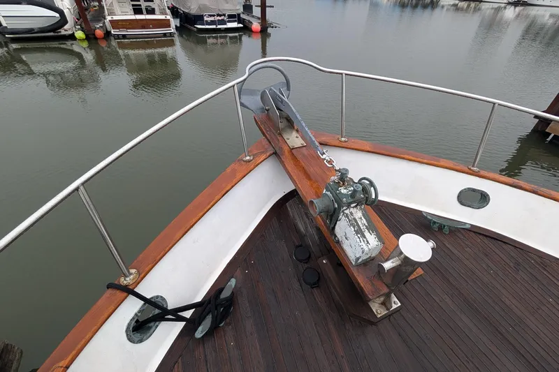 Moments Notice Yacht Photos Pics Bow of 1981 Sea Ranger 47 yacht with anchor and wooden deck.