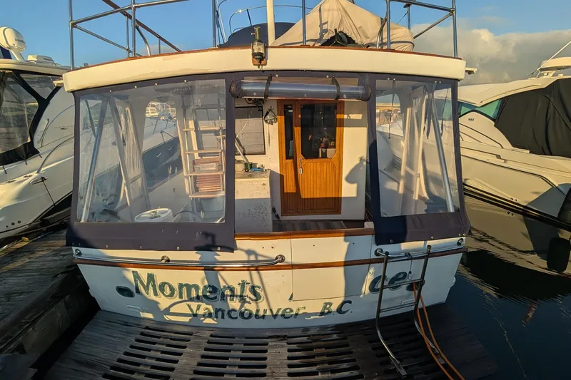 Moments Notice Yacht Photos Pics 1981 Sea Ranger 47 yacht docked in Vancouver, B.C., with covered deck and wooden door.