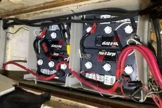 Moments Notice Yacht Photos Pics Battery compartment of a 1981 Sea Ranger 47 boat with connected cables.