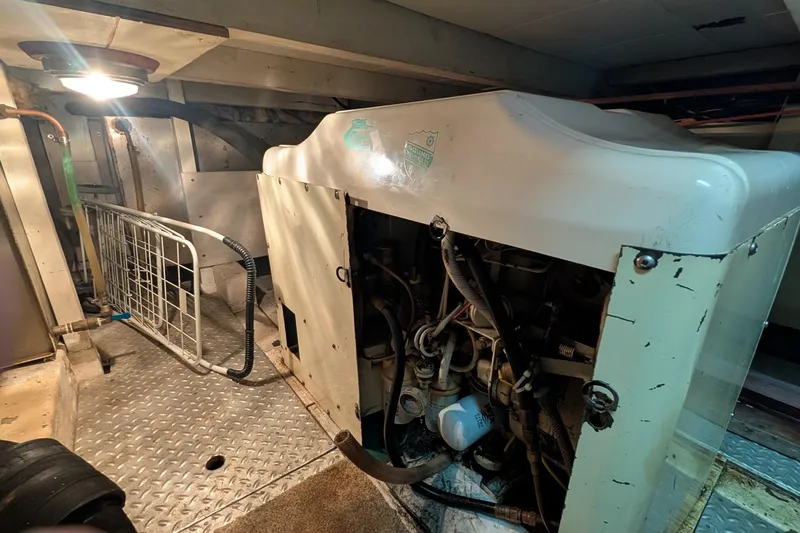 Moments Notice Yacht Photos Pics Engine room of 1981 Sea Ranger 47 yacht with visible machinery and equipment.