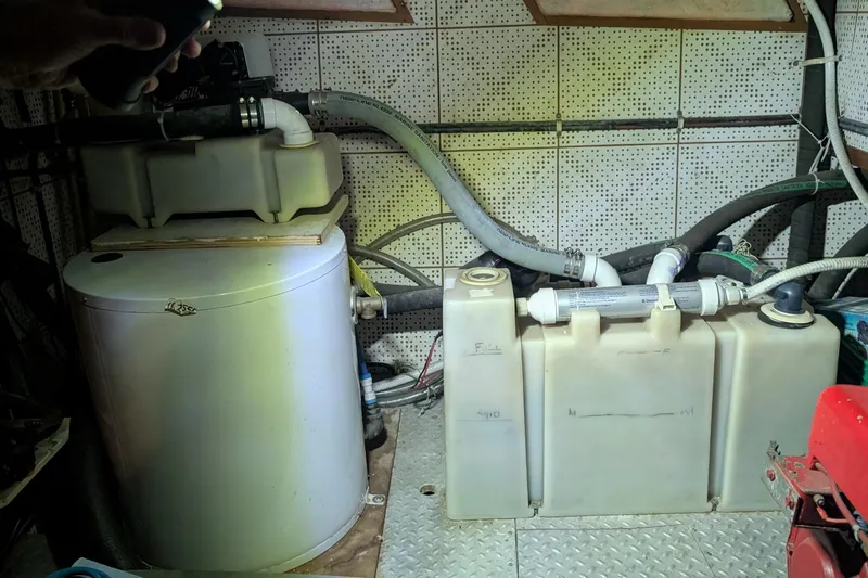 Moments Notice Yacht Photos Pics Engine room of 1981 Sea Ranger 47 with water tanks and plumbing system.