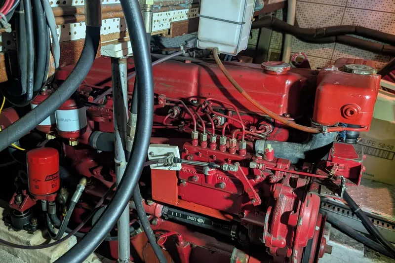 Moments Notice Yacht Photos Pics 1981 Sea Ranger 47 engine room with red machinery and cables.