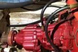 Moments Notice Yacht Photos Pics Red engine component of a 1981 Sea Ranger 47 boat, featuring hoses and mechanical parts.