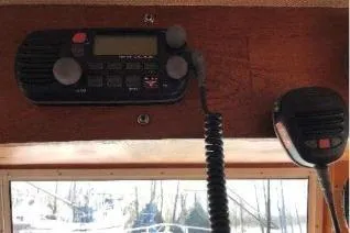 Moments Notice Yacht Photos Pics 1981 Sea Ranger 47 boat radio and microphone setup on wooden panel.