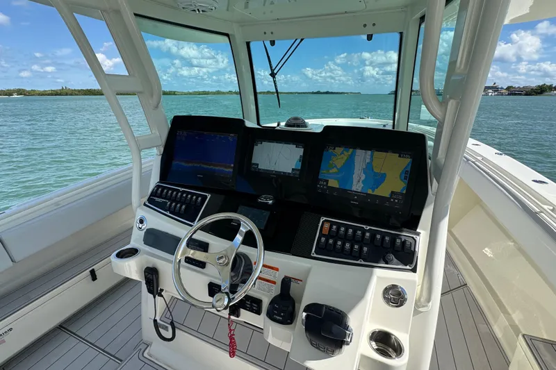  Yacht Photos Pics Helm of 2017 HCB 42 Siesta boat with navigation screens and steering wheel.