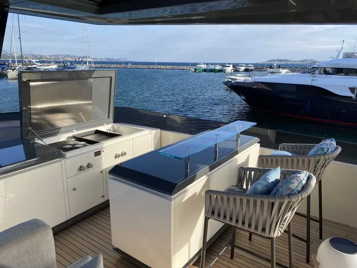  Yacht Photos Pics Luxurious 2020 Ferretti Yachts 850 with outdoor bar and seating, docked at marina.